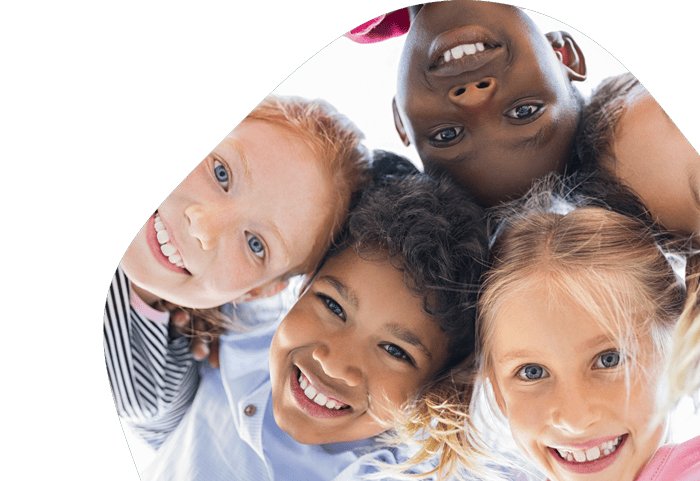 group of diverse children looking down at the camera